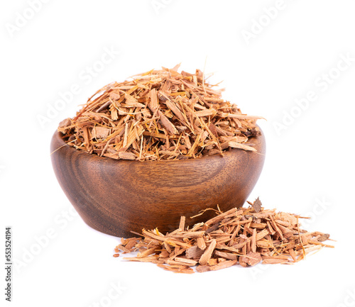 Catuaba bark in wooden bowl, isolated on white background. Trichilia catigua bark. Chuchuhuasha, Tatuaba, Pau de Reposta, Piratancara and Caramuru. photo