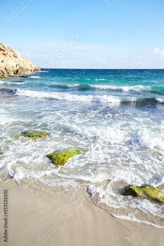Fototapeta Naklejka Na Ścianę i Meble -  Sand beach, summer sea with blue sky. Sea water with white wave. Cala azzurra beach, Favignana island, Trapani, Sicily, Italy. A beautiful seascape