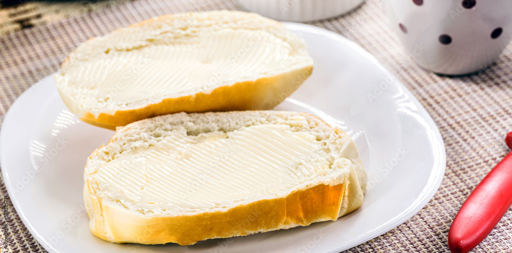 slice of salt bread cut with butter, called French bread in Brazil, Brazilian breakfast