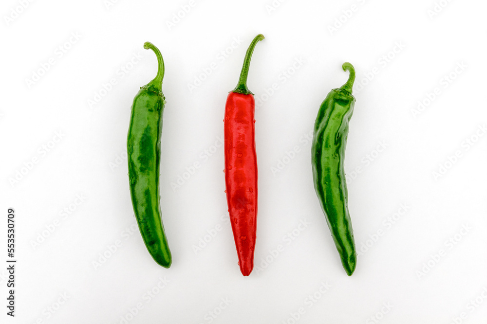 Red pepper between green peppers.