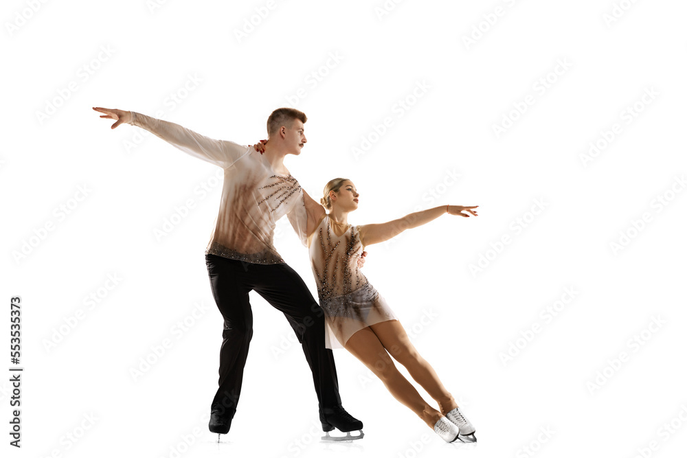 Portrait of young man and woman, figure skating athletes performing isolated over white studio background Portrait of young man and woman, figure skating athletes performing isolated over white studio background