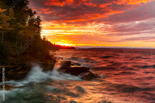 Vivid Sunset over Lake Superior. Sun reflects on the waters as waves crash into an inlet