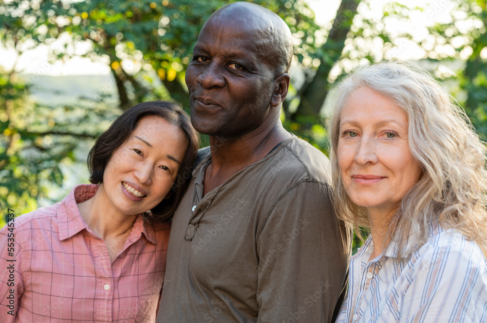 Diverse group of senior male and female friends posing for photo ourdoors