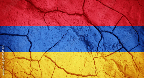 Flag of Armenia. Armenian symbol. Flag on the background of dry cracked earth. Armenian flag with drought concept