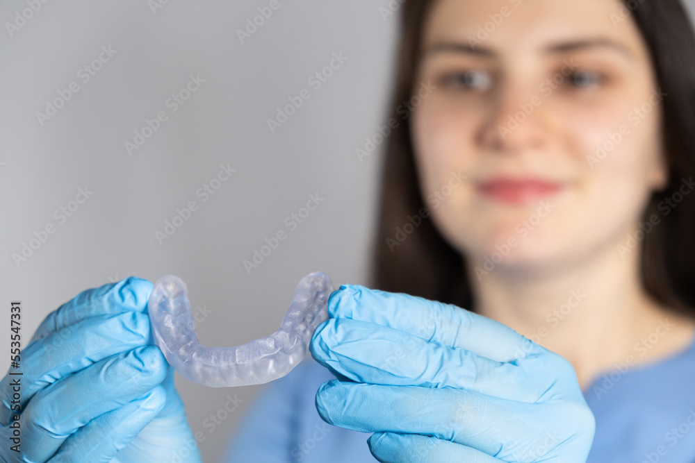 Doctor holding dental mouthguard, splint for the treatment of