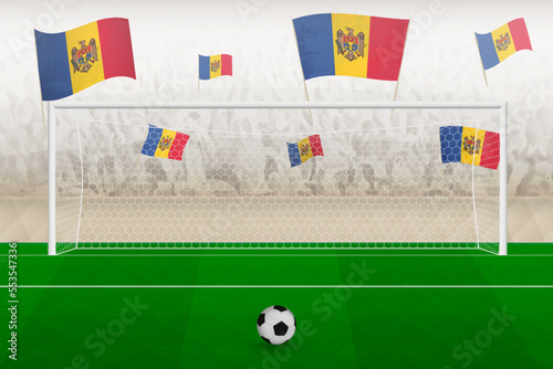 Moldova football team fans with flags of Moldova cheering on stadium, penalty kick concept in a soccer match.