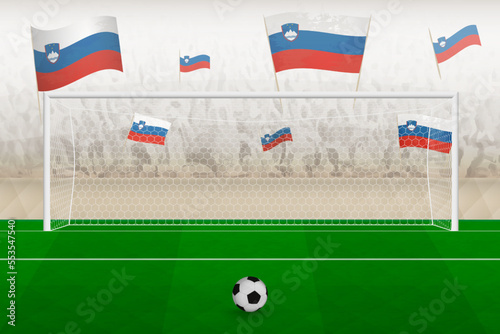 Slovenia football team fans with flags of Slovenia cheering on stadium, penalty kick concept in a soccer match.