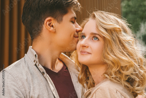 Close up portrait of an in love couple enjoying each others presence outdoors in the street.
