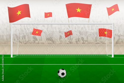 Vietnam football team fans with flags of Vietnam cheering on stadium, penalty kick concept in a soccer match.