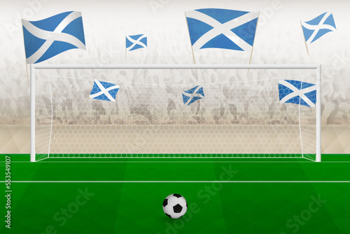 Scotland football team fans with flags of Scotland cheering on stadium, penalty kick concept in a soccer match.