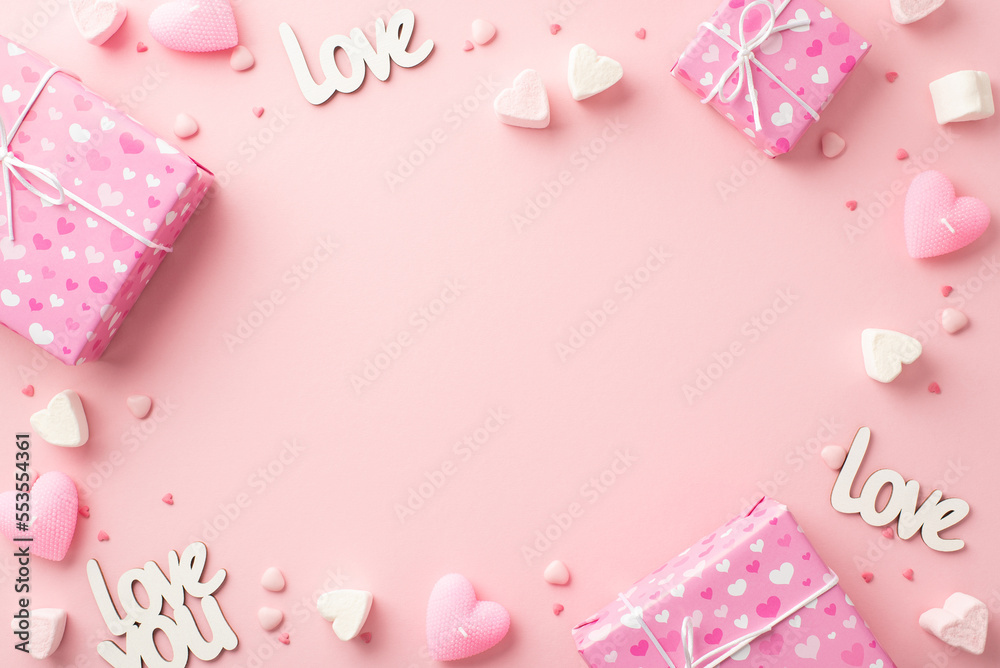 Valentine's Day concept. Top view photo of present boxes heart shaped marshmallow candles inscriptions love and sprinkles on isolated pastel pink background with blank space in the middle
