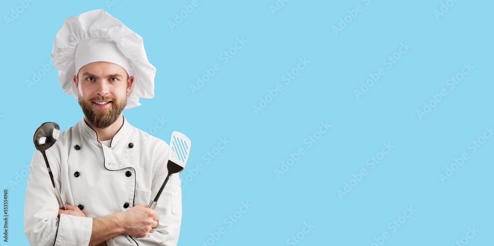 Smiling young Chef in Cooking Uniform Smiling young Chef in Cooking Uniform