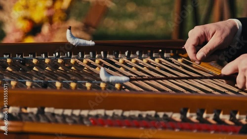 Close up footage of musician playing at cimbalom musical instrument outdoor. photo