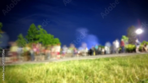 Blurred Timelapse Of Tourists At Night Walking Around Taking Pictures Diverse Group photo