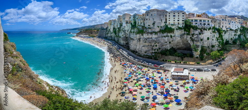 Panoramic view of Tropea – city on cliff with crowded beach and azure sea (Calabria, ITALY)