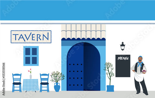 Traditional Greek tavern, typical plants and white and blue Mediterranean architectural and decorative elements. Mustachioed waiter dressed in traditional Greek style.