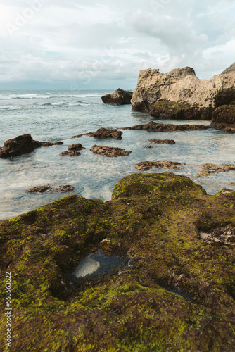 Mossy rocks and formations along the coastline of Suluban Beach; Uluwatu, Bali, Indonesia photo