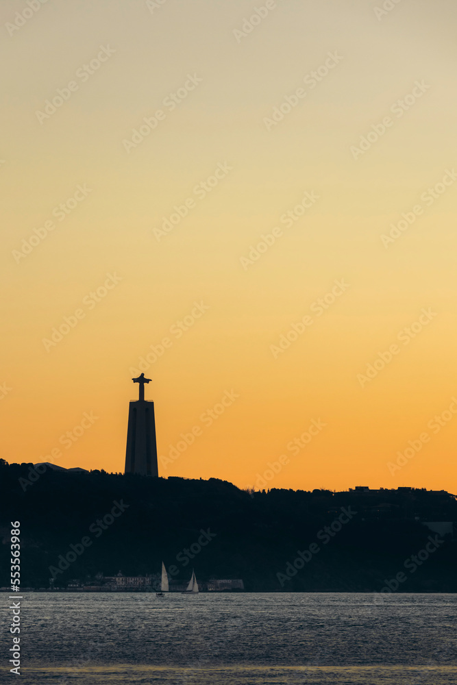 Sanctuary of Christ the King, with a glowing golden sky at sunset; Lisbon, Portugal Sanctuary of Christ the King, with a glowing golden sky at sunset; Lisbon, Portugal