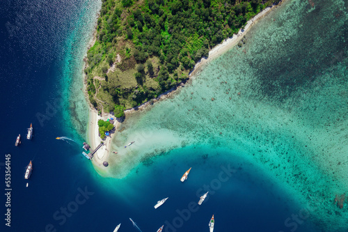 View from directly above of boats moored in the water off Batu Bolong Beach in Komodo National Park; Canggu, Bali, Indonesia photo