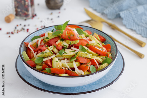 Roasted summer squash Tomato Salad with onion and vinaigrette dressing.