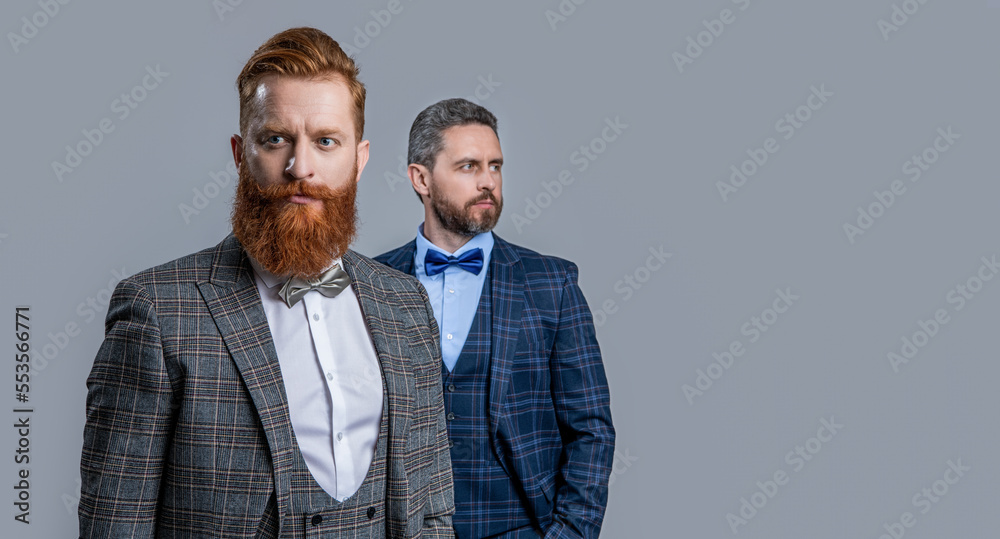 tuxedo gentlemen isolated on grey background with copy space and selective focus. tuxedo gentlemen isolated on grey background with copy space and selective focus.