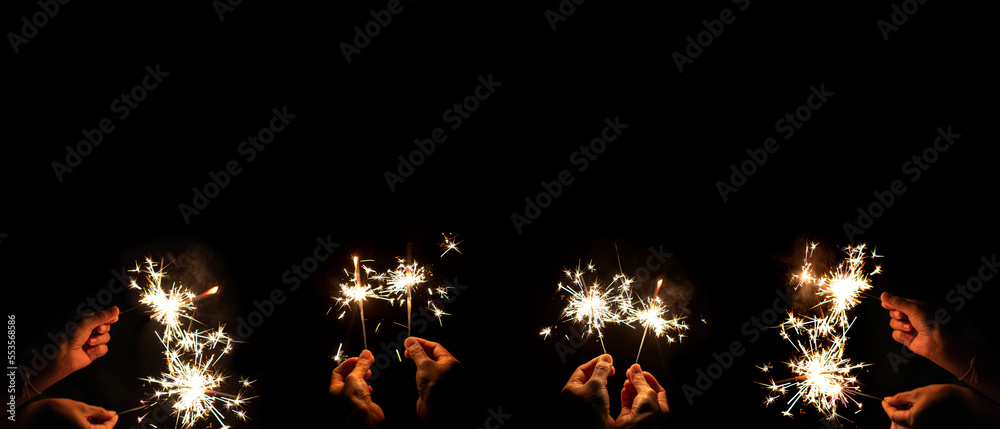 hand holding sparkler isolated on black background symbolizes the new year and celebration,image copy space
