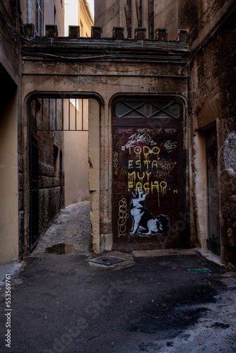 Mediterranean street in the town with graffiti on a metal door  