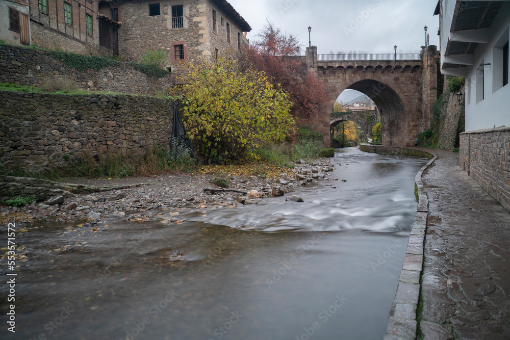 view of a bridge over a river in the village of Potes in Cantabria, Spain