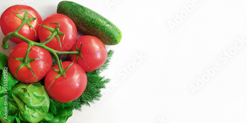 fresh vegetables on a white background. ripe organic tomatoes, cucumber, dill and lettuce as ingredients healthy vegetarian or vegan food