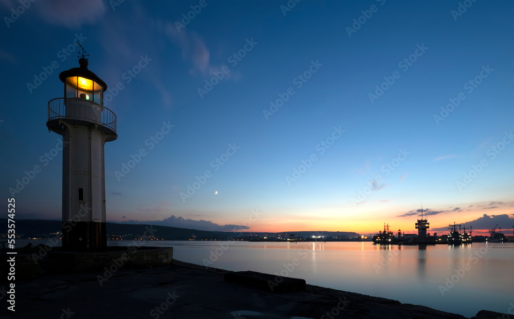 Lighthouse at sunset in Varna, Bulgaria. Sea port and coastal view.