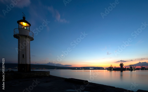 Lighthouse at sunset in Varna, Bulgaria. Sea port and coastal view.