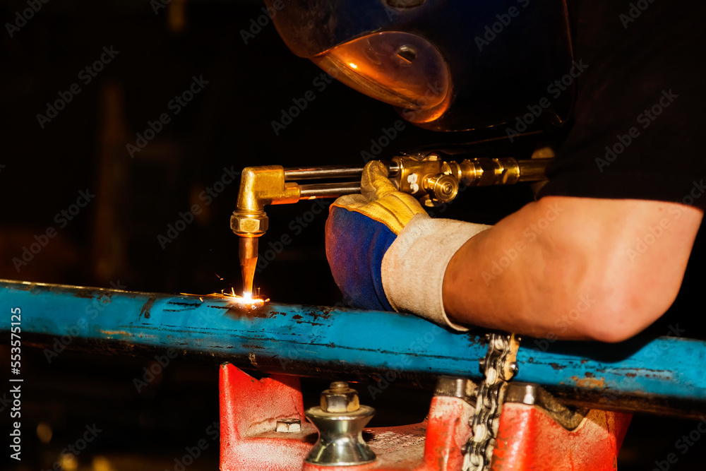 A journeyman pipe fitter in a metal fabrication plant using an