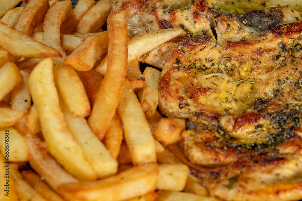 Roasted chicken with french fries close up Roasted chicken with french fries close up