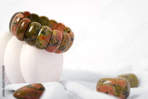 Natural unakite stone bracelet on isolated white background. Unisex. Isoteric. photo