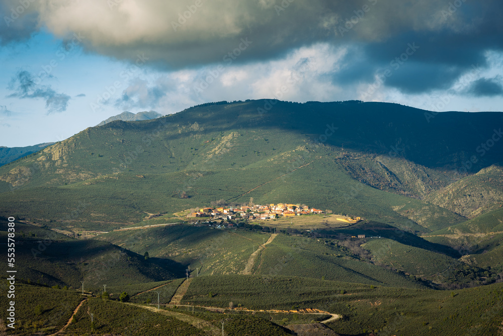 Scenic alpine landscape with the small village of El Atazar and beautiful clouds above mountains, Madrid, Spain