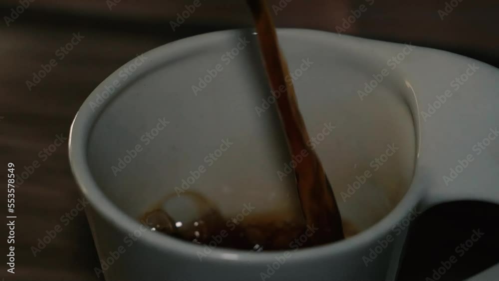 Slow Motion Pouring Black Coffee Into Cup. Fresh Morning Pour Over Black Tea Close Up. Selective Focus. Slow Motion Pouring Black Coffee Into Cup. Fresh Morning Pour Over Black Tea Close Up. Selective Focus.