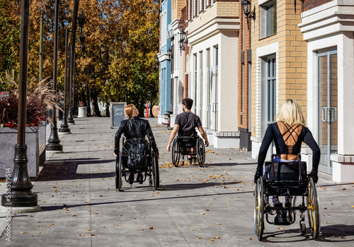 Wallpaper Mural Three young paraplegic friends spending time together moving down a walkway outside in a city area; Edmonton, Alberta, Canada Torontodigital.ca
