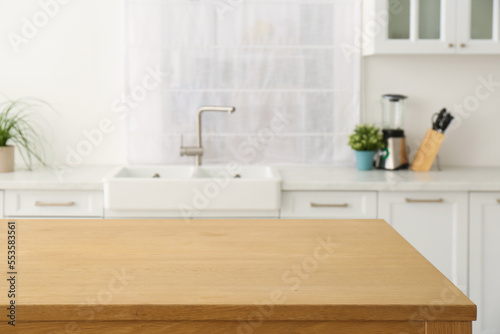 Stylish wooden table in kitchen. Interior design