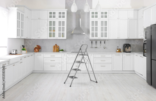Billede på lærred New metal stepladder on floor in kitchen