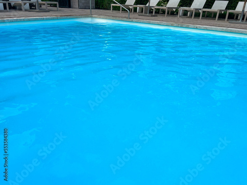 Outdoor swimming pool in luxury hotel on sunny summer day. Time for relax