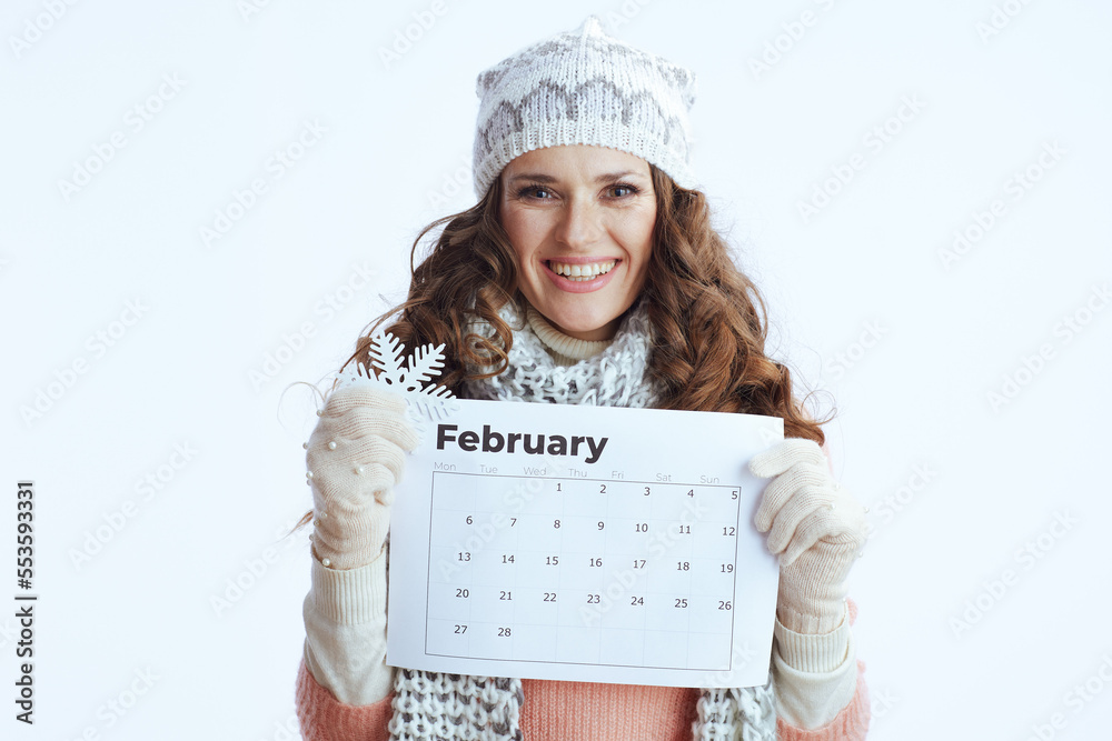 Portrait of happy female in sweater, mittens, hat and scarf on Portrait of happy female in sweater, mittens, hat and scarf on