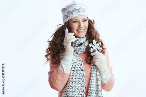 smiling modern woman on white speaking on smartphone