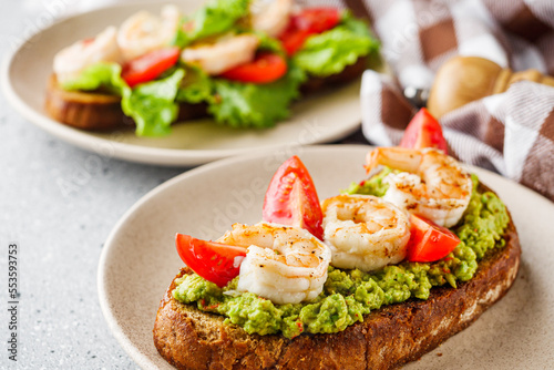 delicious Italian bruschetta with shrimps on a gray stone background