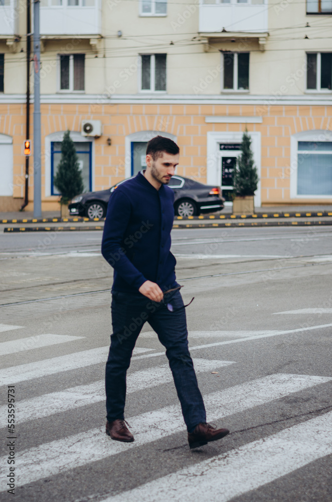 a man with glasses in his hand crosses the road a man with glasses in his hand crosses the road