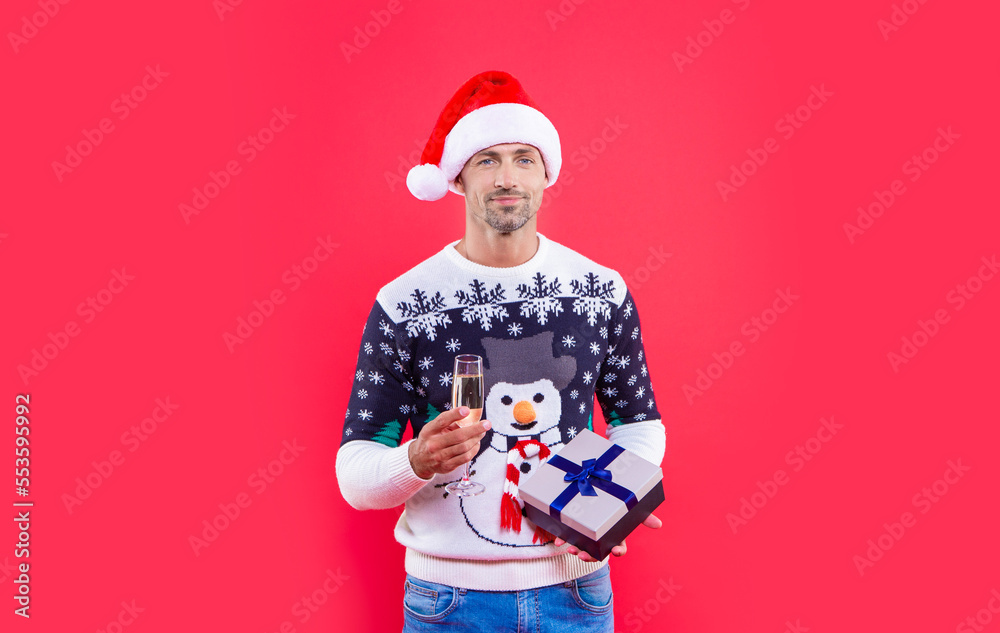 happy new year man isolated on red background. man hold present for new year in studio.