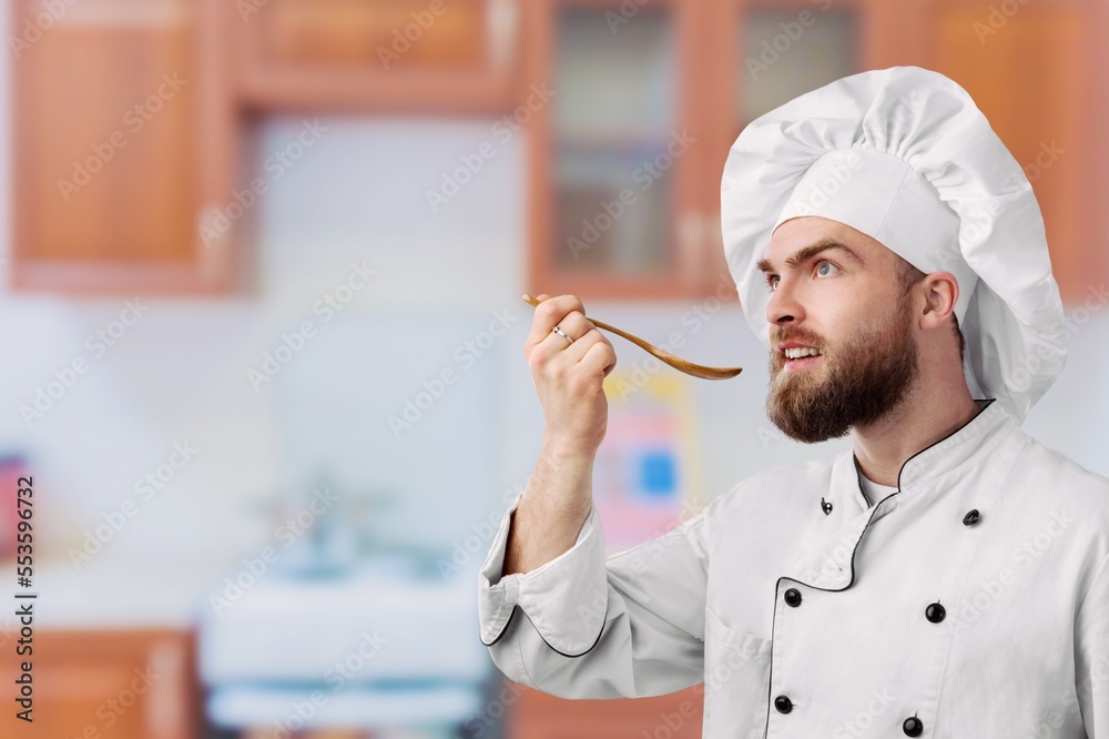 Smiling young Chef in Cooking Uniform