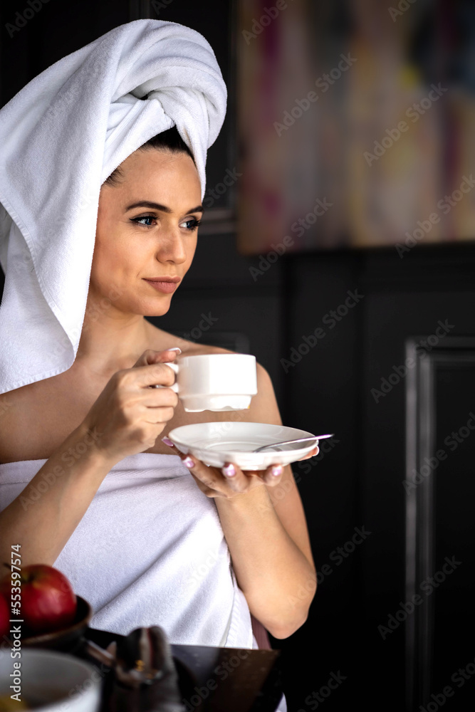 Closeup smiling morning lady in white towel relaxing drinking coffee cup breakfast at home hotel Closeup smiling morning lady in white towel relaxing drinking coffee cup breakfast at home hotel