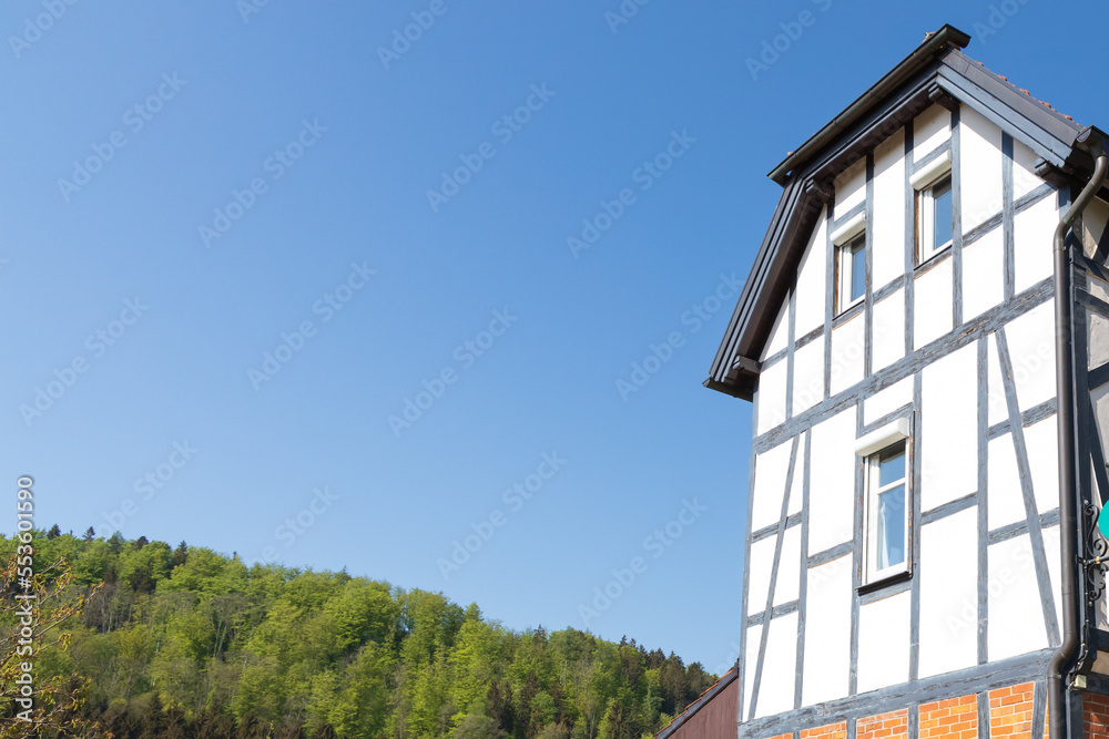 Half-timbered house with forest background in Germany