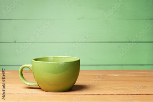 Green classic ceramic mug on table