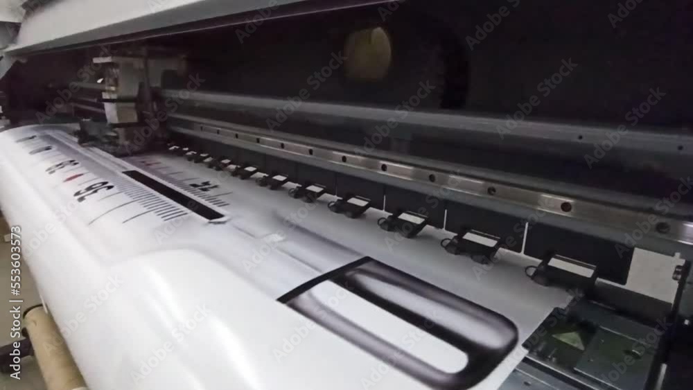 modern printer printing on wide format. Oracal photo printing. Head of printer during foto printing process. printer prints photo of thermometer for advertising sticker. Large format printing machine modern printer printing on wide format. Oracal photo printing. Head of printer during foto printing process. printer prints photo of thermometer for advertising sticker. Large format printing machine